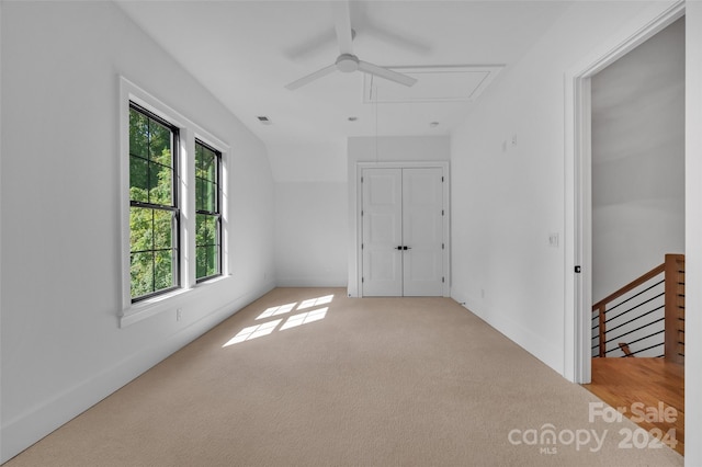 unfurnished bedroom featuring ceiling fan and light colored carpet