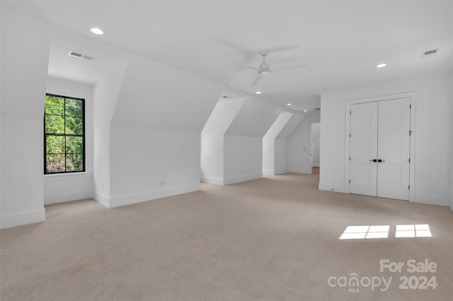 bonus room featuring lofted ceiling, ceiling fan, and light colored carpet