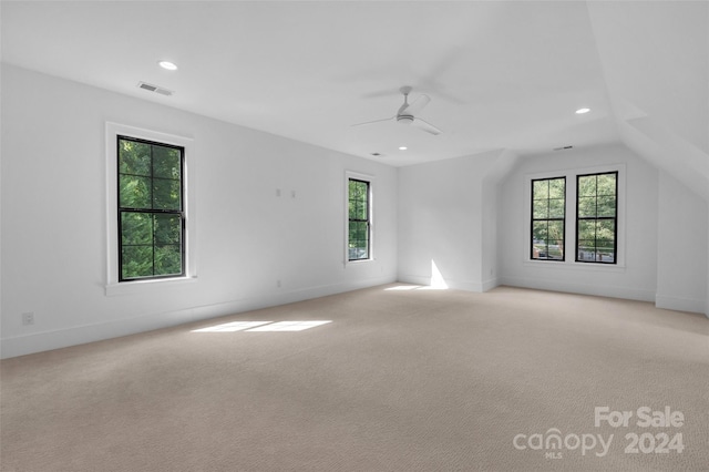 interior space featuring lofted ceiling, ceiling fan, and a wealth of natural light