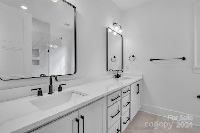 bathroom featuring vanity and a shower with shower door