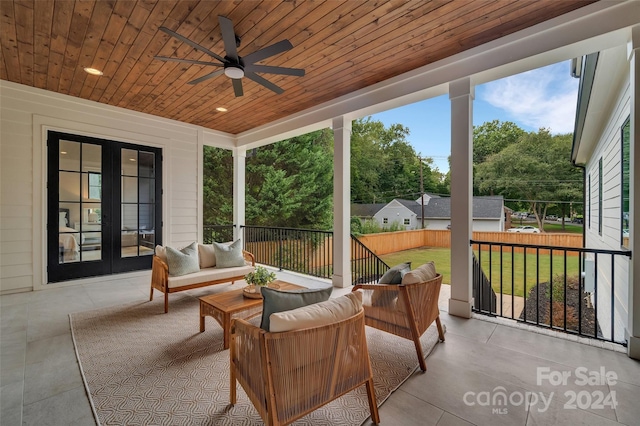 sunroom with wooden ceiling and ceiling fan