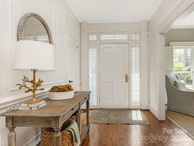 foyer entrance featuring hardwood / wood-style flooring and ornamental molding