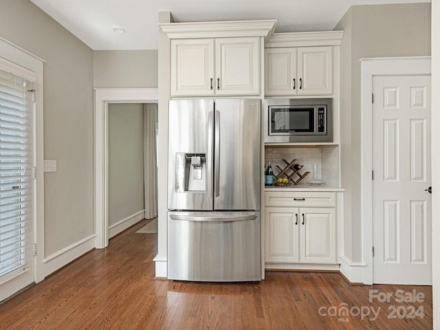 1218 Wareham Ct, Charlotte, NC 28207 - kitchen featuring appliances with stainless steel finishes, decorative backsplash, dark wood finished floors, and baseboards
