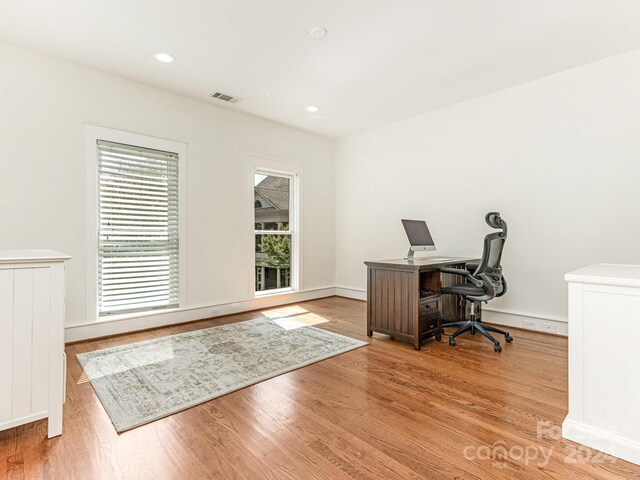 home office featuring light wood-type flooring and a healthy amount of sunlight