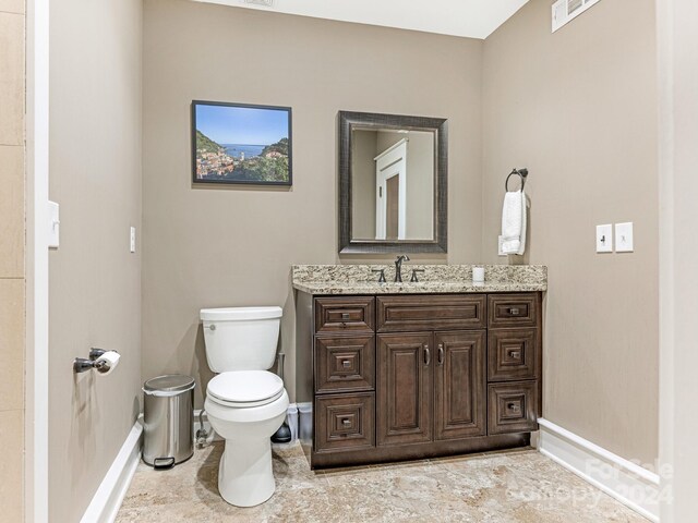 bathroom with tile patterned flooring, toilet, and vanity