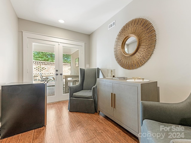 living area featuring french doors and hardwood / wood-style flooring