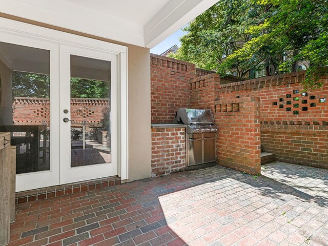 view of patio featuring a grill, exterior kitchen, and french doors