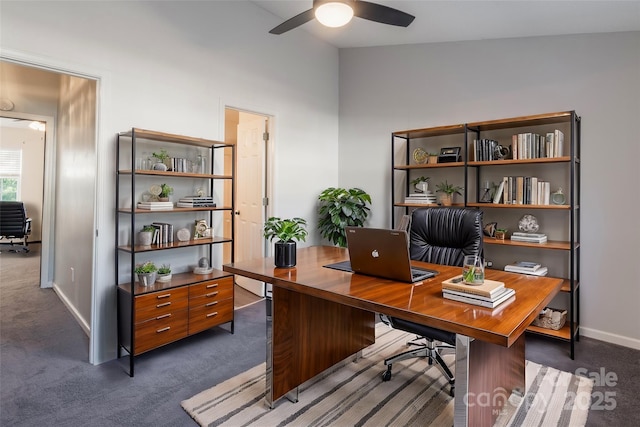 office area with carpet flooring, a ceiling fan, and baseboards