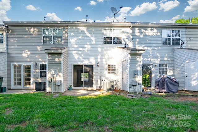 back of property featuring a patio area, central air condition unit, and a yard