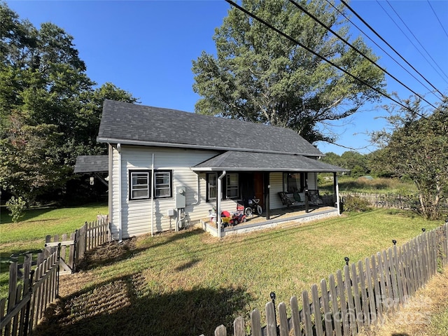 bungalow-style house featuring a front lawn and a patio