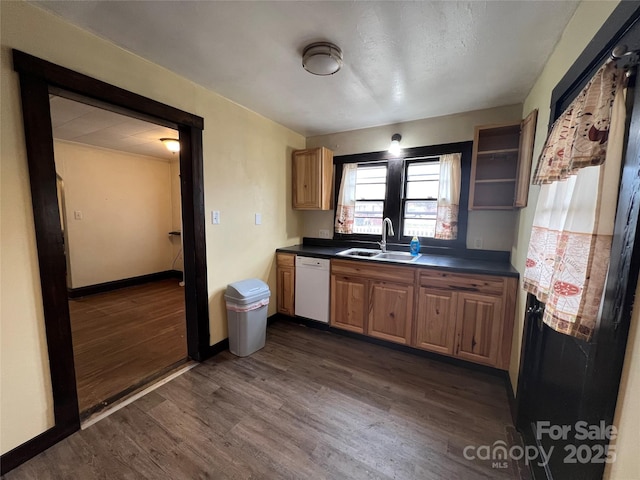 kitchen with dark wood-type flooring, white dishwasher, and sink