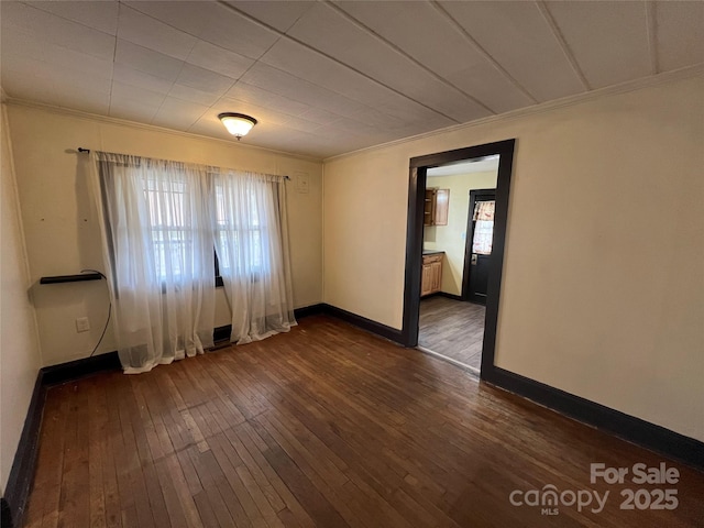 spare room with crown molding and dark hardwood / wood-style floors