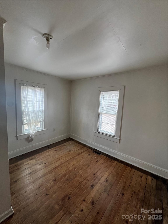 unfurnished room with dark hardwood / wood-style floors