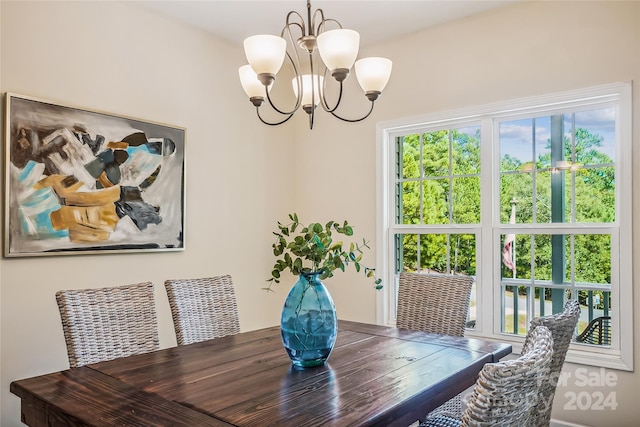 dining space featuring an inviting chandelier and hardwood / wood-style flooring