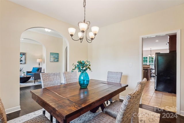 dining room featuring an inviting chandelier and tile patterned floors