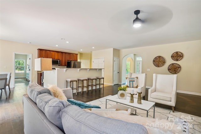 living room featuring ceiling fan and light hardwood / wood-style floors