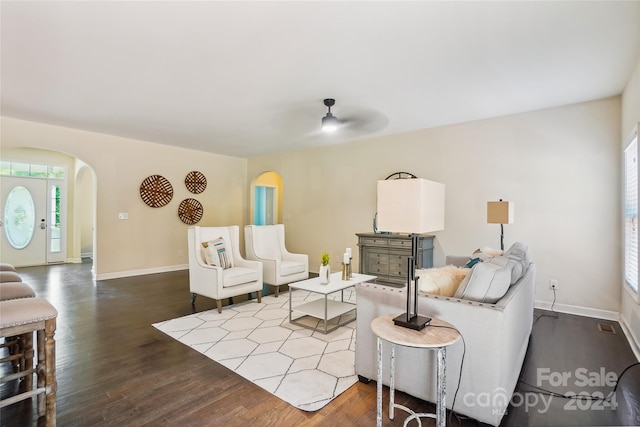 living room with ceiling fan and dark hardwood / wood-style floors