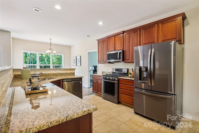 kitchen featuring light tile patterned floors, decorative light fixtures, appliances with stainless steel finishes, a notable chandelier, and sink