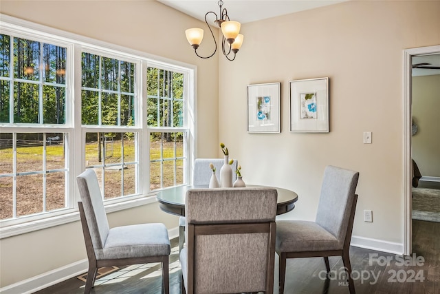 dining room featuring dark hardwood / wood-style flooring and a chandelier