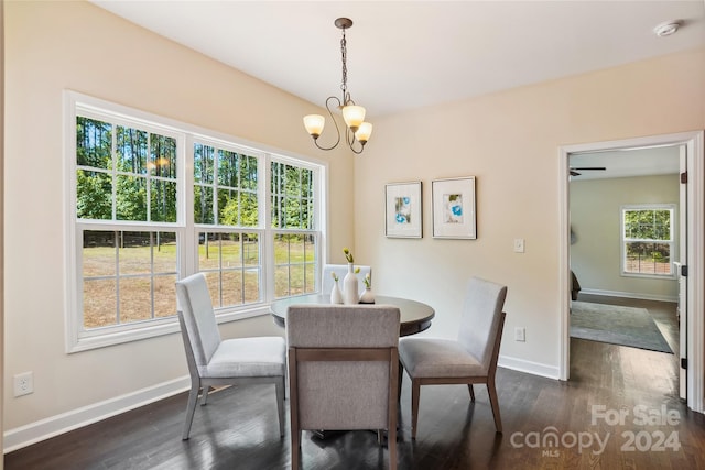 dining area with dark hardwood / wood-style flooring and a chandelier