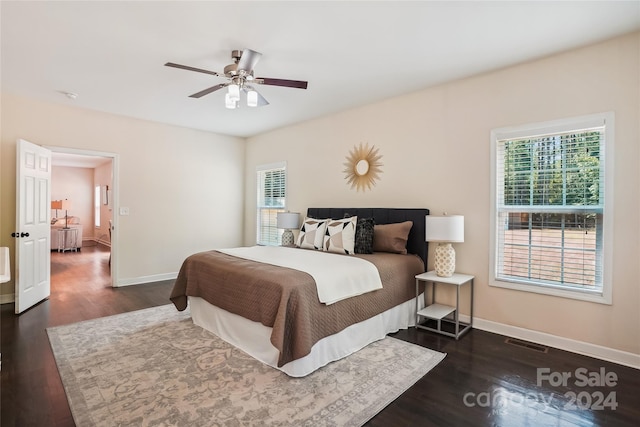 bedroom with ceiling fan, dark hardwood / wood-style floors, and multiple windows