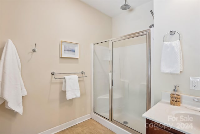 bathroom with vanity, tile patterned flooring, and a shower with door