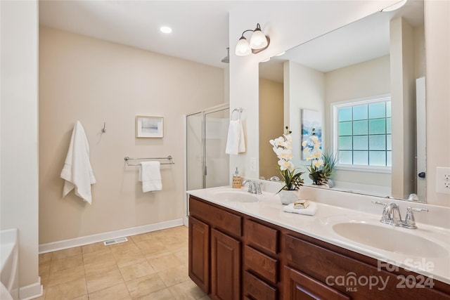 bathroom with vanity, tile patterned flooring, and a shower with door