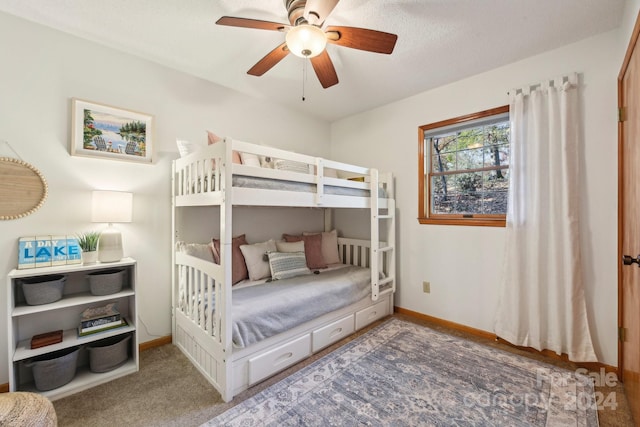 bedroom with a textured ceiling, carpet, and ceiling fan