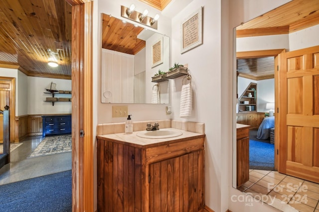 bathroom featuring ornamental molding, tile patterned flooring, vanity, and wood ceiling