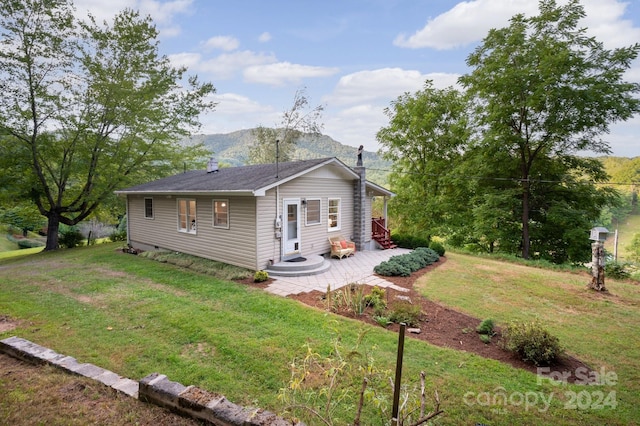 ranch-style home featuring a front yard and a patio