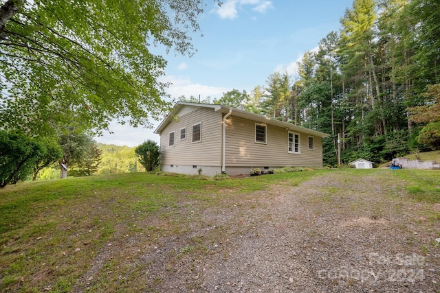 view of home's exterior featuring a storage shed