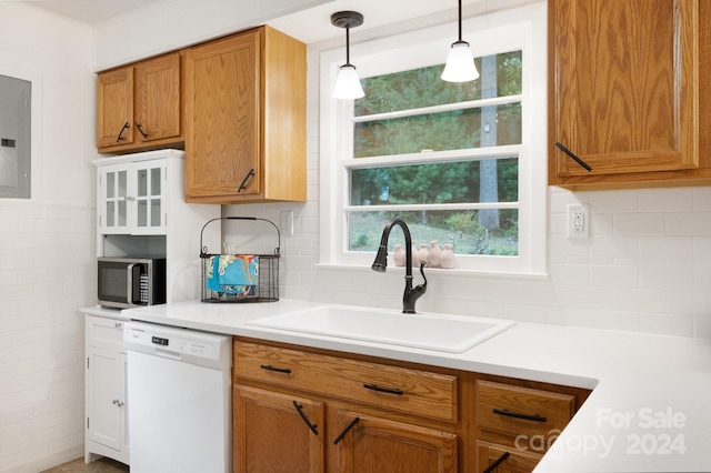 kitchen featuring decorative light fixtures, dishwasher, backsplash, sink, and electric panel