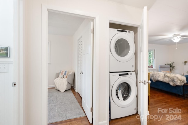 laundry room featuring stacked washer and clothes dryer, ceiling fan, and hardwood / wood-style flooring