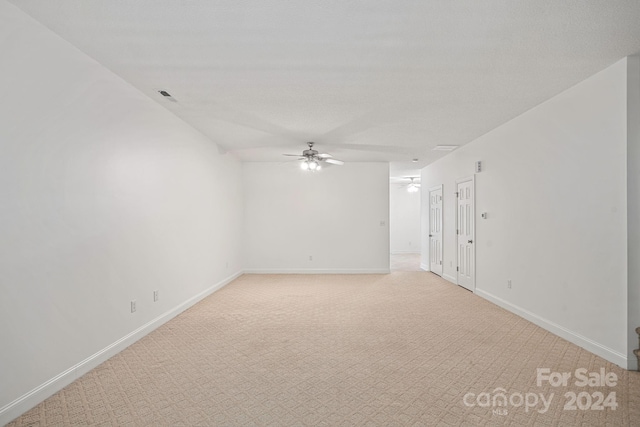 unfurnished room with ceiling fan and light colored carpet