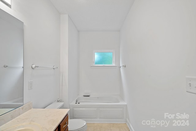 bathroom featuring a tub, toilet, and vanity