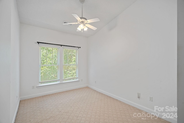 carpeted empty room featuring lofted ceiling and ceiling fan