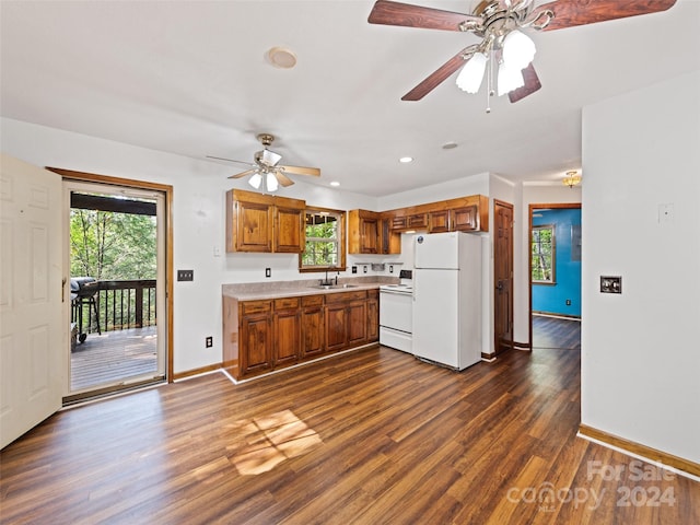 kitchen with white appliances, dark hardwood / wood-style floors, ceiling fan, and plenty of natural light