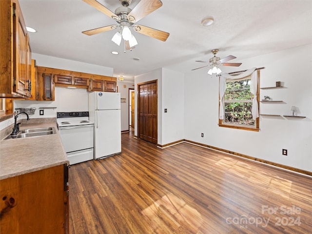 kitchen with white appliances, sink, ceiling fan, and dark hardwood / wood-style flooring