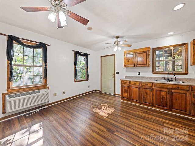 kitchen with ceiling fan, dark hardwood / wood-style flooring, and a wealth of natural light