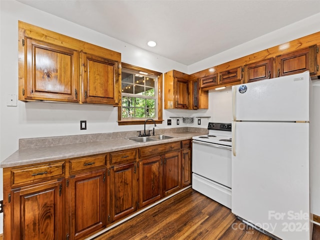 kitchen featuring white appliances, dark hardwood / wood-style floors, and sink