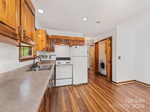 kitchen with white appliances, dark hardwood / wood-style flooring, washer / clothes dryer, and sink