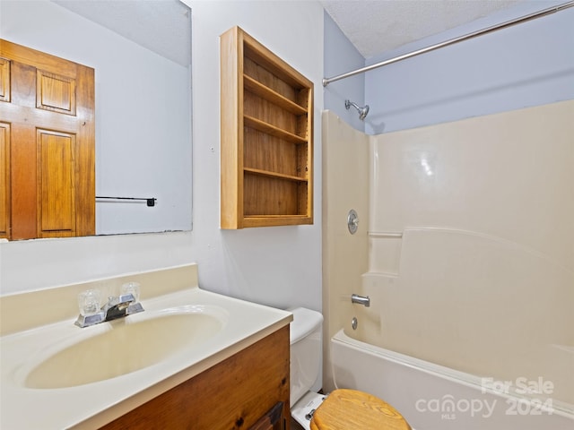 full bathroom featuring a textured ceiling, vanity, toilet, and  shower combination