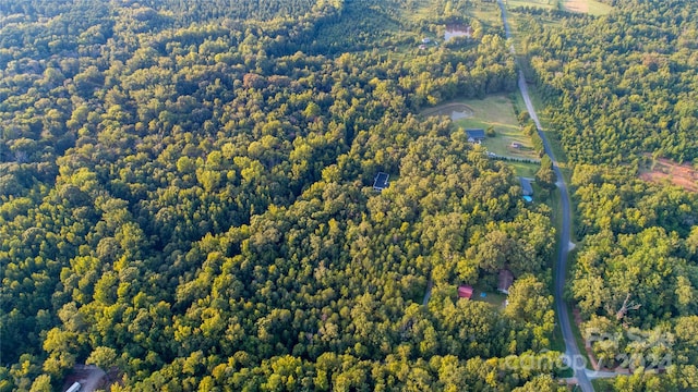 birds eye view of property featuring a view of trees
