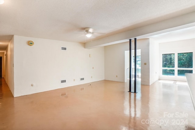 unfurnished room featuring a textured ceiling and ceiling fan