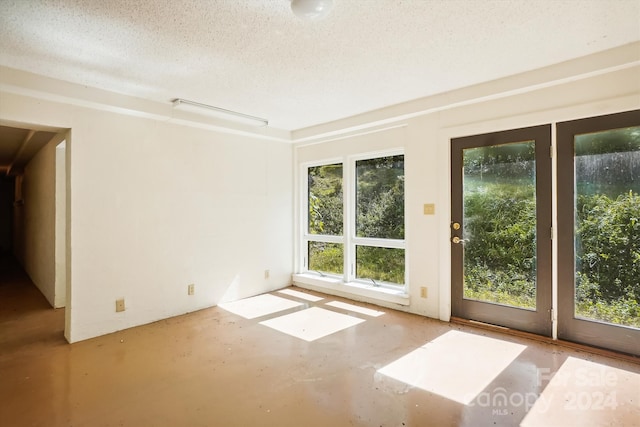 empty room featuring a textured ceiling