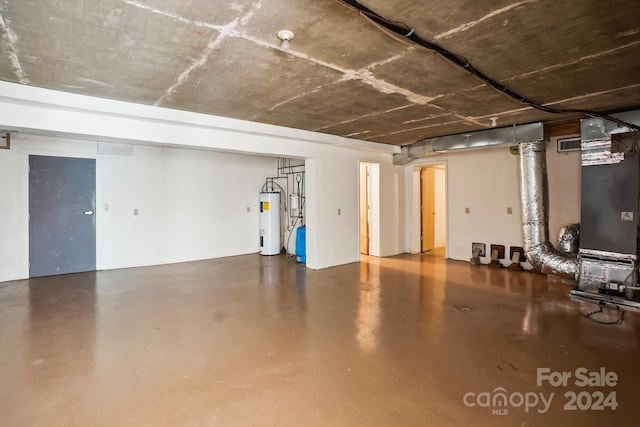 basement featuring water heater and heating unit