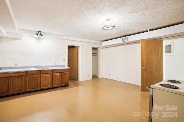 interior space featuring sink and a textured ceiling