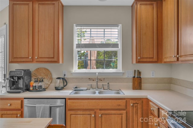 kitchen featuring stainless steel appliances, brown cabinets, light countertops, and a sink