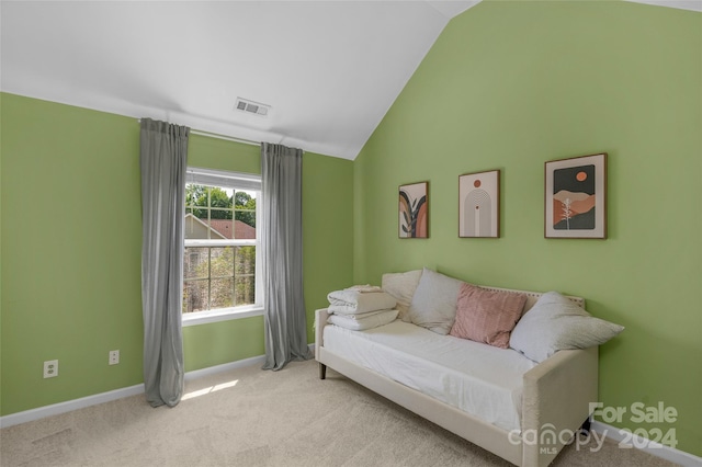 sitting room featuring lofted ceiling, baseboards, visible vents, and carpet