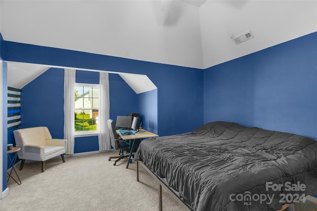 carpeted bedroom featuring lofted ceiling and visible vents